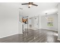 Open living room with sleek wood-look floors, complemented by modern light fixtures and neutral tones at 2430 Little Gem Loop, Sanford, FL 32773