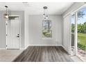 Bright living space featuring wood-look flooring, sliding doors, and a view of the outdoors at 2430 Little Gem Loop, Sanford, FL 32773