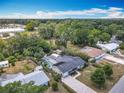 Aerial view of a charming home with a screened pool and a spacious, treed lot at 2550 Meadowview Ln, Deland, FL 32720