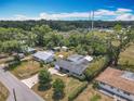 Aerial view of a charming home with a screened pool and a spacious, treed lot at 2550 Meadowview Ln, Deland, FL 32720