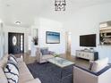 Bright living room featuring tile flooring, modern furniture, and large windows at 2620 Abbey Ave, Orlando, FL 32833