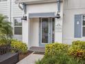 Inviting front entrance with stylish door, decorative address sign, and manicured landscaping at 2920 On The Rocks Pt, Kissimmee, FL 34747