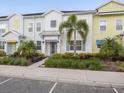 Townhouse exterior showcasing a charming facade, well-kept landscaping, and front entrance at 2920 On The Rocks Pt, Kissimmee, FL 34747