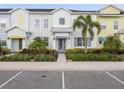 Charming townhouse with colorful facade, landscaped yard, and welcoming front entrance at 2920 On The Rocks Pt, Kissimmee, FL 34747