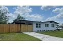 Well-maintained single-Gathering home with fenced yard and well manicured lawn at 331 N Dollins Ave, Orlando, FL 32805