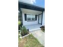 Inviting covered front porch with freshly painted steps and minimalist landscaping at 331 N Dollins Ave, Orlando, FL 32805
