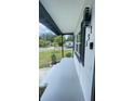 Relaxing covered front porch with minimalist plants and dark trim at 331 N Dollins Ave, Orlando, FL 32805