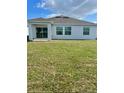 Expansive backyard featuring a covered patio and lush green grass at 33836 Sky Blossom Cir, Leesburg, FL 34788