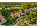 Beautiful home featuring a tile roof, an arched entry, and a courtyard, nestled in lush greenery at 3512 Legacy Hills Ct, Longwood, FL 32779