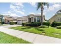 Beautiful home featuring a brick driveway and complemented by lush green landscaping at 4737 Maple Park St, Orlando, FL 32811