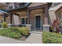 Inviting front porch with stone accents and a blue front door at 5119 Jones Rd, St Cloud, FL 34771