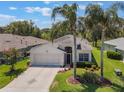 Inviting single-story home with lush lawn, mature landscaping, and a convenient two-car garage at 5560 Squires Dr, Leesburg, FL 34748