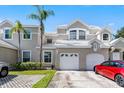 Home exterior showcasing a two-car garage, well-kept landscaping, and concrete driveway at 6955 Della Dr # 41, Orlando, FL 32819
