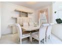 Bright dining room with neutral decor, stylish furniture, and plenty of space at 7323 Cypress Grove Rd # 87, Orlando, FL 32819