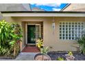 Inviting front entrance with a decorative door and glass block window, providing natural light at 8248 Limetree Ct, Orlando, FL 32836