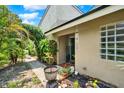 Inviting front entrance with garden features and a charming wind chime at 8248 Limetree Ct, Orlando, FL 32836