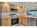 Well-lit kitchen featuring stainless steel appliances and bright cabinets, offering modern convenience at 8248 Limetree Ct, Orlando, FL 32836
