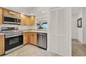 Updated kitchen offers stainless steel appliances and light wood cabinets with ample counter space at 8248 Limetree Ct, Orlando, FL 32836