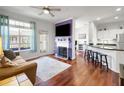 Open concept living room with hardwood floors, ceiling fan, and a view to the kitchen at 860 N Orange Ave # 448, Orlando, FL 32801