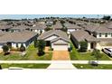 Aerial view of a well-maintained residential neighborhood, highlighting the home's location within the community at 9356 St Therese St, Groveland, FL 34736