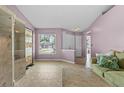 Inviting living room with tile flooring, neutral walls, natural light, and comfortable seating at 9447 Brackin St, Orlando, FL 32825