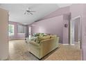 Bright living room with tile flooring, neutral walls, comfortable seating, and natural light at 9447 Brackin St, Orlando, FL 32825