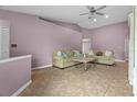 Spacious living room featuring tile floors, high ceilings, comfortable seating, and neutral paint at 9447 Brackin St, Orlando, FL 32825