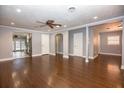 Bright living room with hardwood floors, ceiling fan, and neutral color scheme at 1502 E Gore St, Orlando, FL 32806