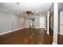 Bright living room with hardwood floors, ceiling fan, and neutral color scheme at 1502 E Gore St, Orlando, FL 32806