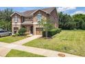 Two-story townhome with a one-car garage, lush green lawn, and beautiful landscaping at 1551 Peterson Pl, Sanford, FL 32773
