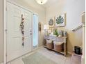 Inviting foyer with tiled floor, decorative wall art, and a charming console table at 1551 Peterson Pl, Sanford, FL 32773