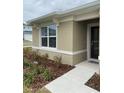 Close-up of the front entry, showcasing the exterior and landscaping at 1575 Aspen Ave, Davenport, FL 33837