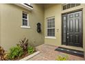 Inviting entryway with brick pavers, decorative fountain, and elegant front door at 1601 Stargazer Ter, Sanford, FL 32771