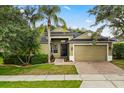 Lovely home features a brick driveway, well-manicured lawn, and an attached two-car garage at 1601 Stargazer Ter, Sanford, FL 32771