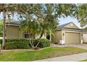 Beautiful home boasts a brick driveway, lush landscaping, and an attached two-car garage at 1601 Stargazer Ter, Sanford, FL 32771