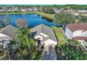 Aerial view of home backing to a pond at 16741 Rising Star Dr, Clermont, FL 34714