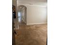 Inviting living room with tan flooring and access to kitchen and hallway at 2007 Dixie Belle Dr # 2007 M, Orlando, FL 32812
