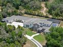 Aerial view showcasing the property's layout, including the pool, landscaping, and ample parking at 20199 Sweetwood Ln, Clermont, FL 34715