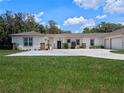 Beautiful exterior with a large driveway, lush lawn, and well-maintained landscaping at 20199 Sweetwood Ln, Clermont, FL 34715