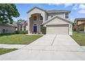 Beautiful two-story home with a spacious driveway and attached two-car garage at 231 Chestnut Creek Dr, Apopka, FL 32703
