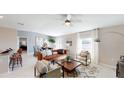 Bright living room featuring stylish furniture, ample natural light, and an open floor plan at 245 Streamliner Way, Groveland, FL 34736