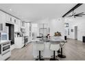 Modern kitchen with white cabinetry, black marble countertops, and sleek, stainless steel appliances at 2520 Oakington St, Winter Garden, FL 34787