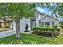 Stylish home featuring well-maintained landscaping and a two-car garage, framed by a lush, green lawn at 2776 Joseph Cir, Oviedo, FL 32765