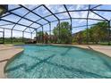 Sparkling screened-in pool surrounded by lush landscaping providing a private and relaxing outdoor retreat at 2801 Boat Cove Cir, Kissimmee, FL 34746