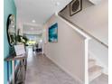 Inviting entryway with tile flooring, staircase, and views into the adjacent dining area at 3635 Fort Mellon Ln, Sanford, FL 32773