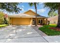 Inviting home exterior with a two-car garage, brick-lined walkway, and well-kept landscaping at 400 Bridge Creek Blvd, Ocoee, FL 34761