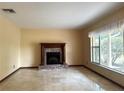 Inviting living room with a fireplace, tile floors, and large windows offering plenty of natural light at 4105 Quando Dr, Belle Isle, FL 32812