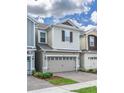 Beautiful two-story home featuring a two-car garage, complemented by lush landscaping and a well-maintained brick driveway at 4313 Gumbo Limbo Dr, Orlando, FL 32822