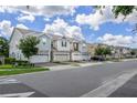 Scenic street view showcasing well-maintained homes with manicured lawns and mature trees, creating a welcoming neighborhood at 4313 Gumbo Limbo Dr, Orlando, FL 32822