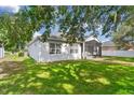 A well maintained exterior featuring an enclosed lanai and a well maintained lawn at 4520 Barrister Dr, Clermont, FL 34711